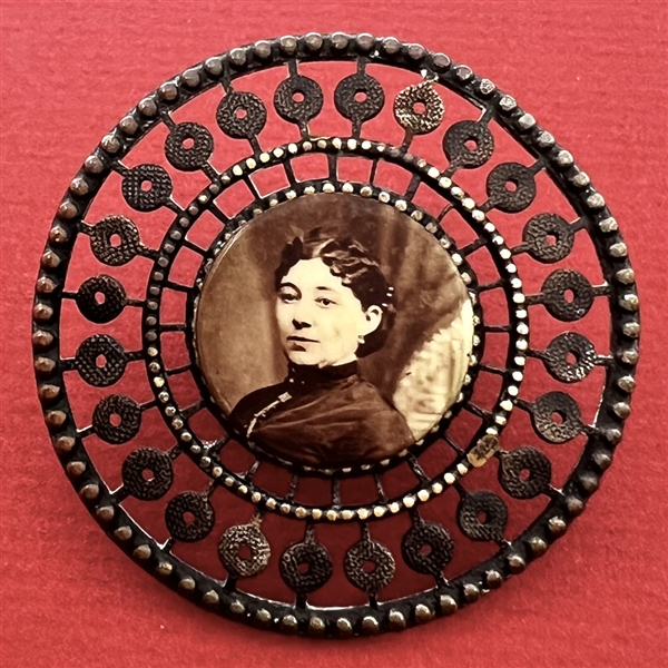 Photographic transfer of a woman set in brass button.