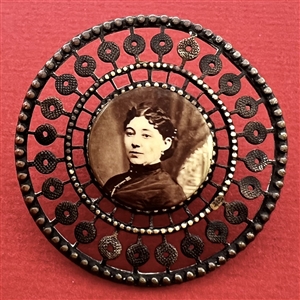 Photographic transfer of a woman set in brass button.