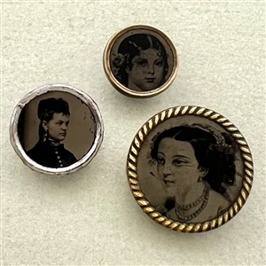 Three tintype buttons of women.