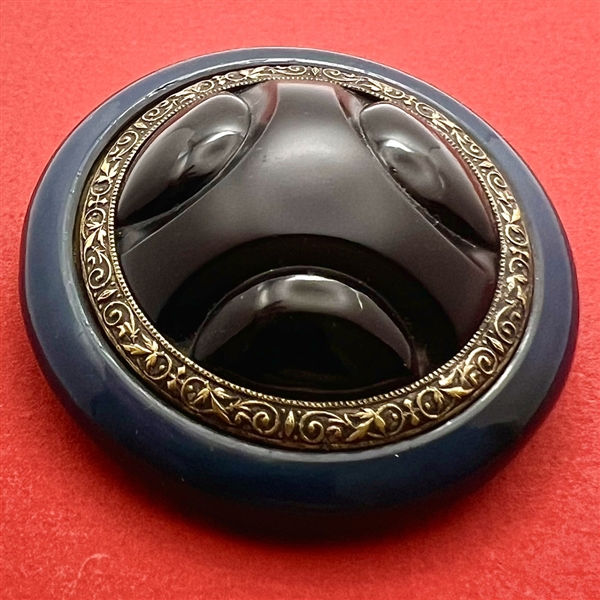 Art Deco black glass with brass and celluloid button.