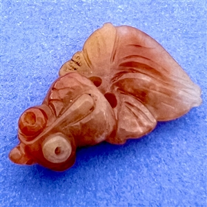 Yellow-orange Jade button of a goldfish.