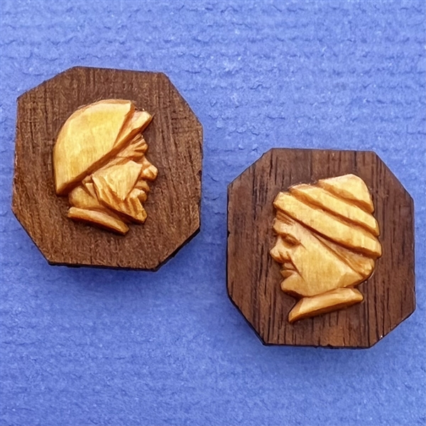 Two carved wood buttons by André Bourgault.