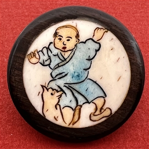 Natural material in boxwood button of an Asian boy playing with a cat.