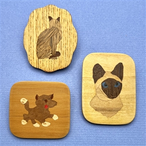 Three marquetry wood studio buttons of cats by Everett Hartman.