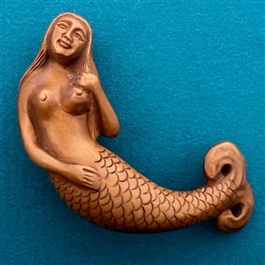 Boxwood button of a mermaid.