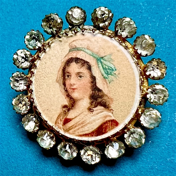 Woman in a bonnet with blue bow button.