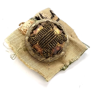 An 18th c. Passementerie button with gold bullion on original fabric.