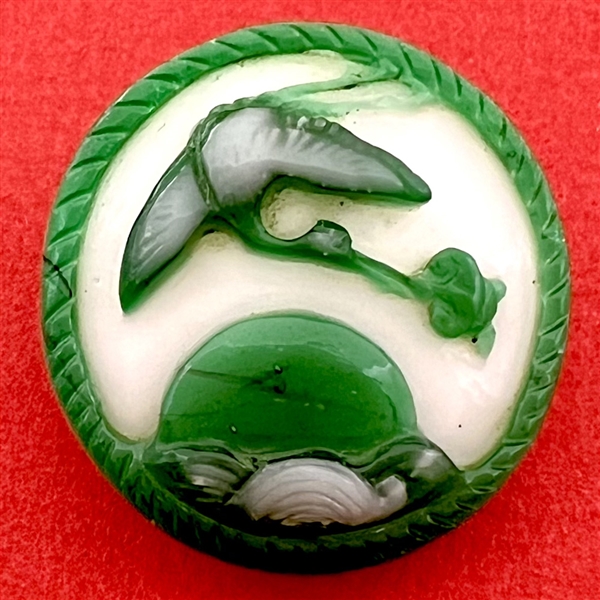 Large Chinese Peking glass button of a heron flying over water with a fish.