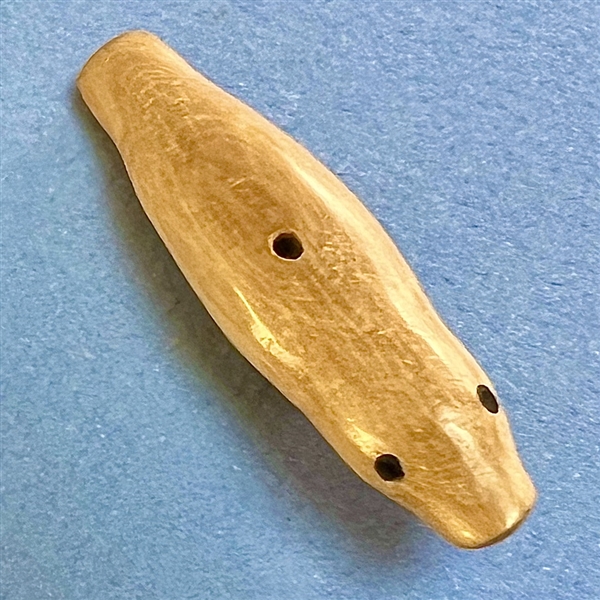 Inuit natural material whistle hole button of a realistic seal.