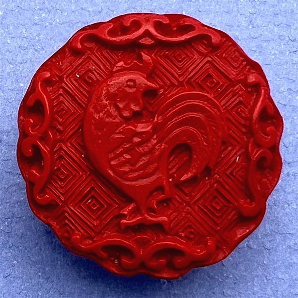 Modern “cinnabar” button of a rooster.