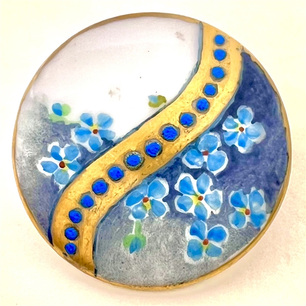 Painted porcelain button of forget-me-not flowers.