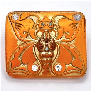 Topsy-Turvy orange glass button of a butterfly and genie wearing a turban.