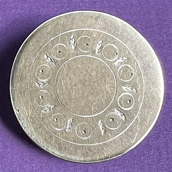 An 18th c. Tombac button with center designs.