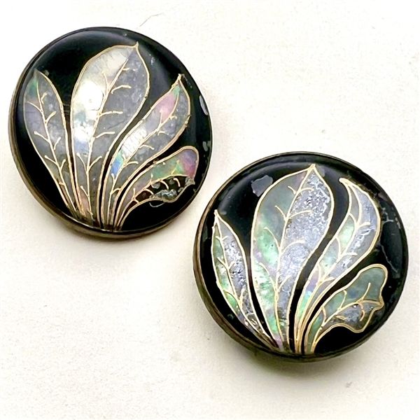 Two reverse painted glass buttons of leaves.