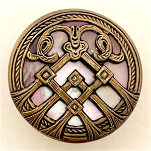 Iridescent pearl button with stylized brass design.