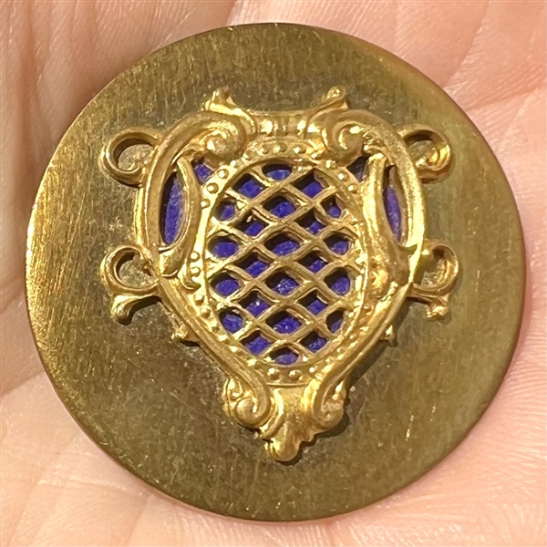 Brass button of a royal shield.