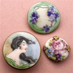 Two painted porcelain buttons and one stud.