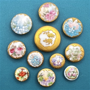 Ten painted porcelain studs of flowers.