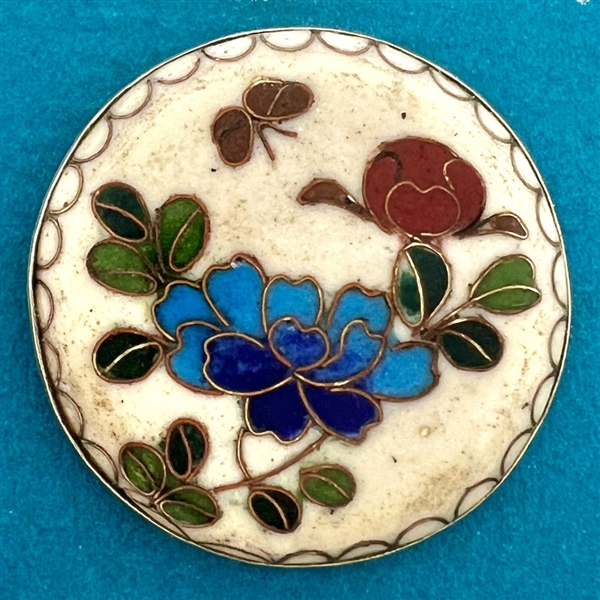 Cloisonné enamel button of flowers.