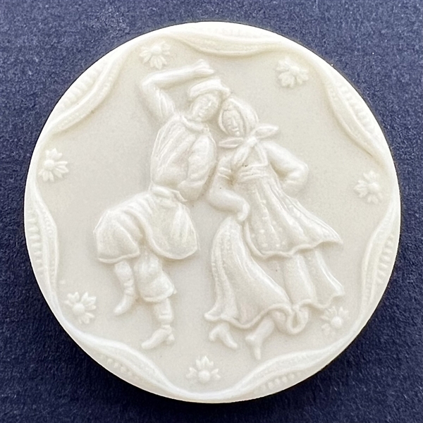 Artid Vintage plastic button of man and woman dancing.