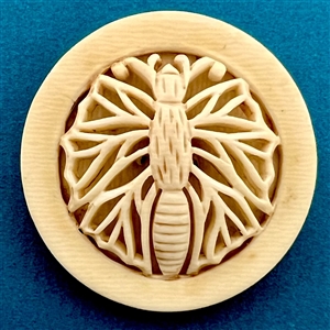 Vintage celluloid button of a stylized butterfly.