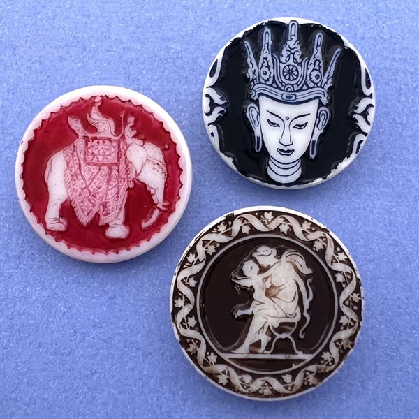 Three Artid Vintage plastic buttons of assorted subjects.