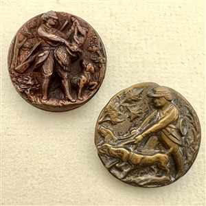 Two French brass sporting buttons of men hunting with dogs.