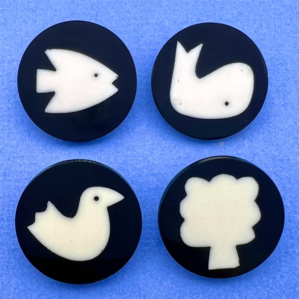 Four polyester cookie buttons of assorted subjects.