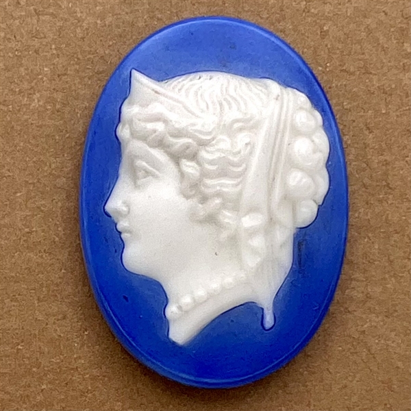 Milk glass rosette shank button with blue of woman’s head.