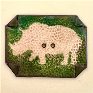 Enamel studio button of a rhinoceros.