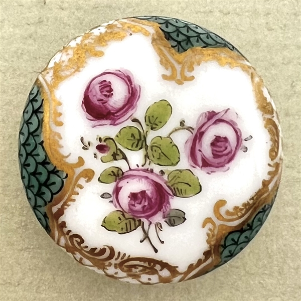 An 18th c. porcelain button of roses and unusual border.