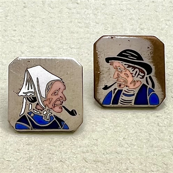 Two 20th c. French silver buttons with enamel of a country couple smoking pipes.