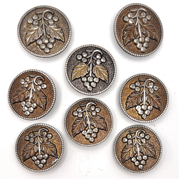 Set of eight bright cut pewter buttons of plant life.