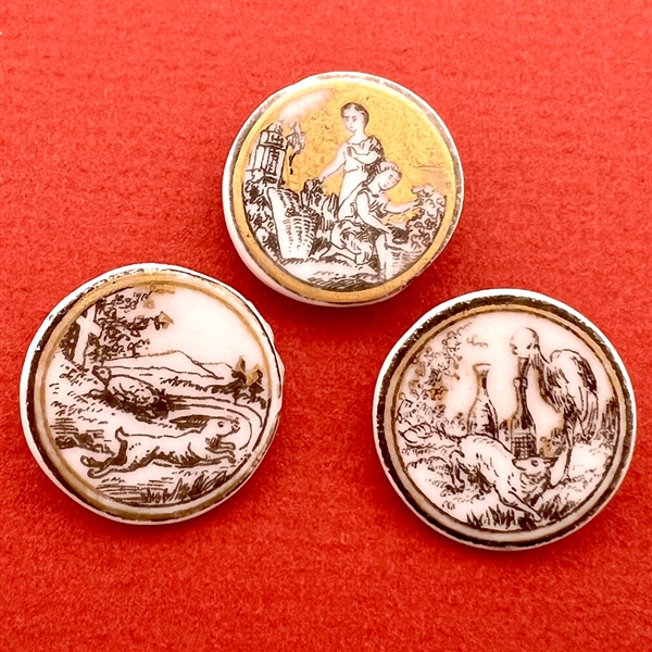 Three transfer on porcelain buttons - two of fables and one of women.