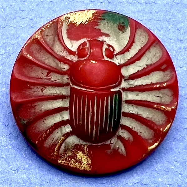 Red glass button of an Egyptian scarab. 