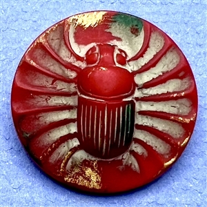 Red glass button of an Egyptian scarab. 