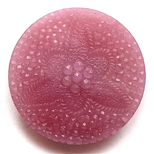 Pink lacy-type glass button of a flower.