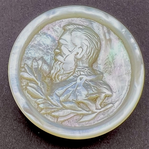 A 19th c. Unusual carved pearl button of man in profile.