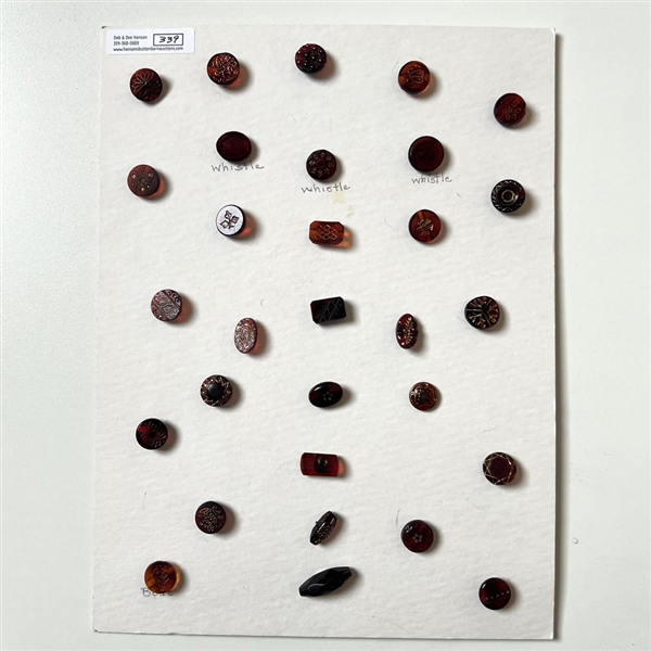 Card of 30 ruby and red glass buttons.