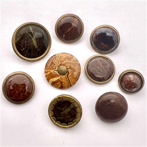 Nine Norwalk pottery buttons.