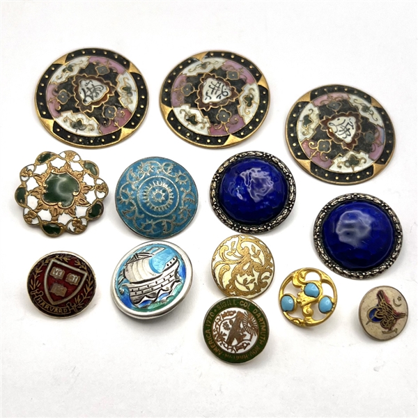 Group of 13 assorted enamel buttons. 