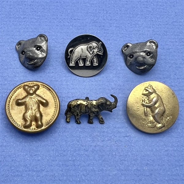 Six teddy bear and elephant buttons.