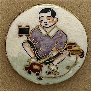 Satsuma button of Japanese boy playing with toys.