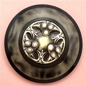 Huge celluloid tight top button with an Ivoroid center.