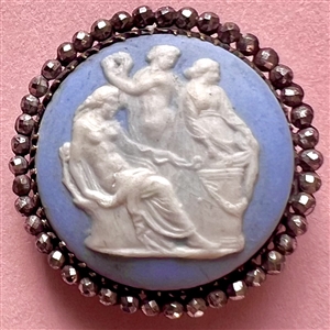 An 18th c. Wedgwood button set in silver (?) of the Three Graces.