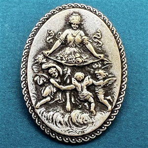 Silvered metal oval button of bountiful goddess with cherubs.