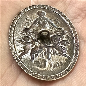 Silvered metal oval button of bountiful goddess with cherubs.
