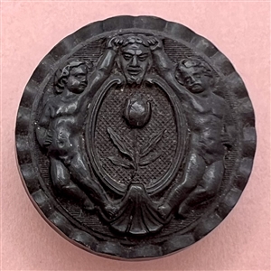 Two Putti holding the horns of a mask of Pan molded horn button.