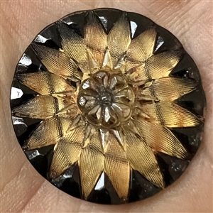 Lacy glass button in a tartan pattern flower.