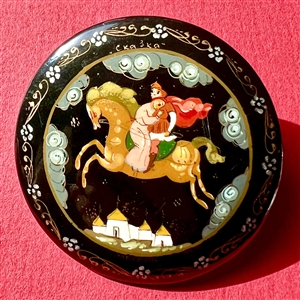 Russian lacquer button of couple on horseback flying through night sky.